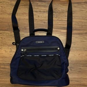 Calvin Klein backpack, navy with black straps and accents.